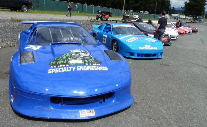 closeup of Specialty Engineering's #74 blue Chevy Camaro race car in the pre-grid lineup formation