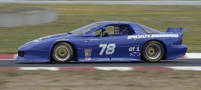 #78 blue Camaro racing car of Andy Pearson in side view racing down the track